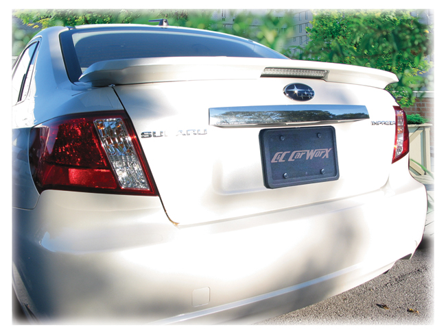 Before Installation of Tape-on
STI-style Rear Trim,
standard chrome panel
is above license plate<