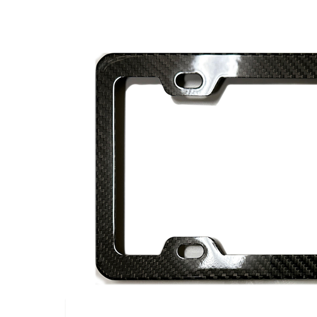 A close-up of the left side of the Glossy Black Carbon Fiber License Plate Frame by C&C CarWorx which fits Any Vehicle with U.S. Plates.