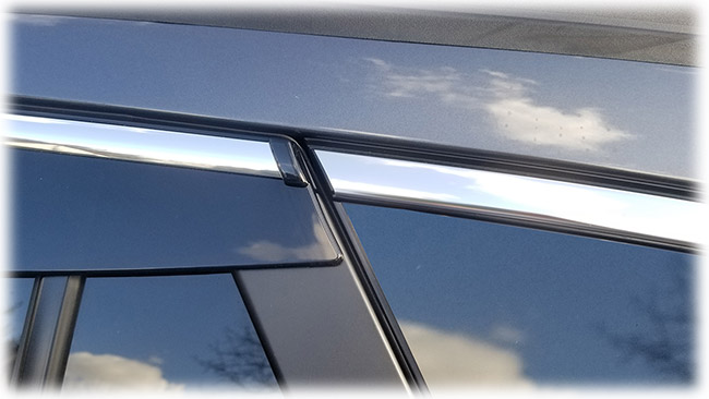 Shown is a close-up of rear edge of high quality Injection-Molded window visor WV-O20-TFI Tape-On Outside-Mount Window Visor Rain Guards With Chrome-Style Accent Trim to complement your model's OEM design and fit 2020, 2021, 2022, 2023, 2024 Subaru Outback Wagon